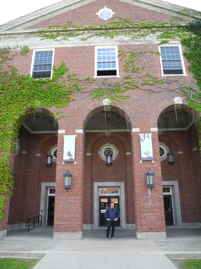 Kyle standing outside one of the college buildings